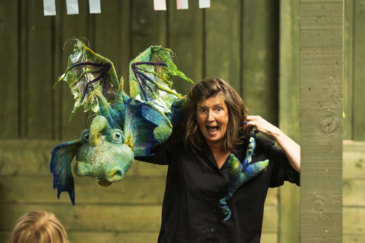 Storyteller Rachel Huggins has a beautiful dragon draped across her shoulders.