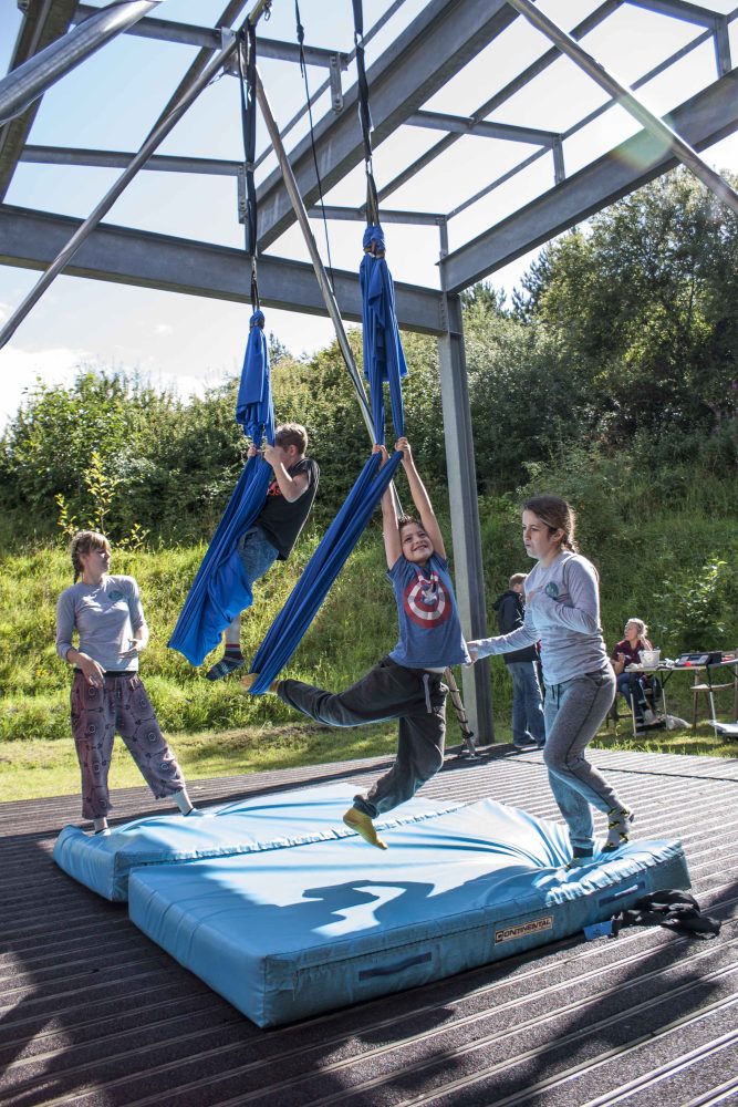 Young people perform on aerial workshops