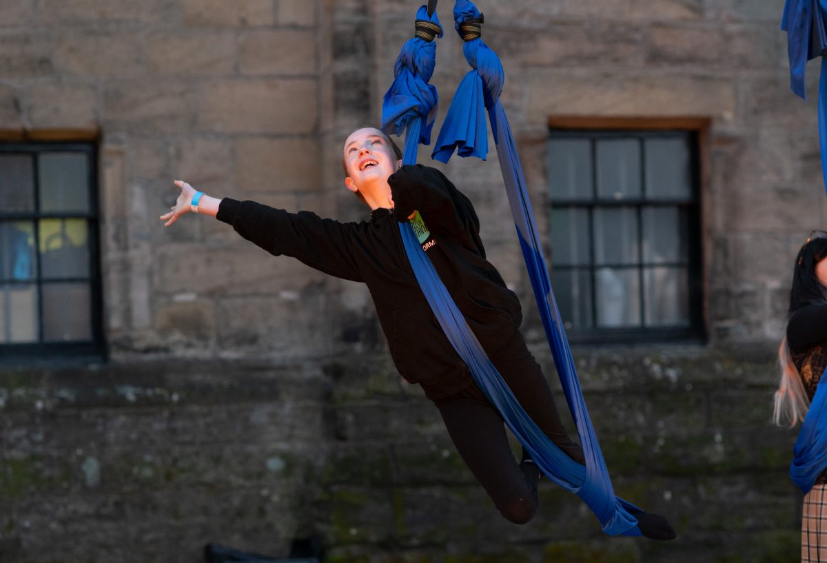 Young people perform on aerial workshops